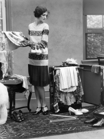 1920s-woman-packing-clothes-for-travel