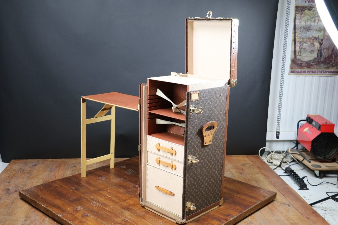 A MADE TO ORDER STOKOWSKI SECRETAIRE MONOGRAM TRUNK