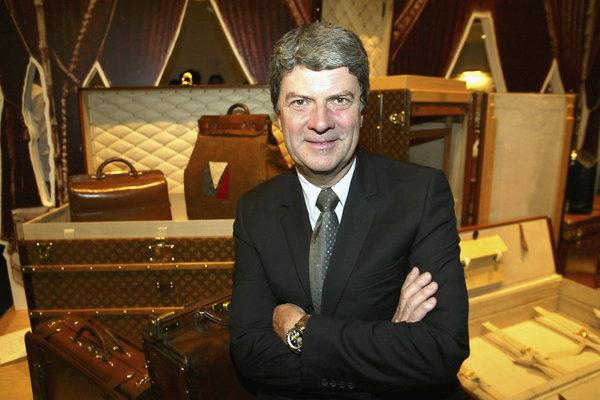 Louis Vuitton President Yves Carcelle poses next to the travel