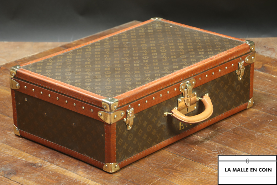 This suitcase from the luxury brand Louis Vuitton is in monogrammed canvas