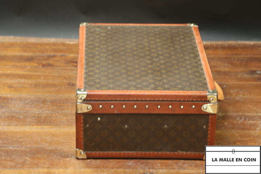 This suitcase from the luxury brand Louis Vuitton is in monogrammed canvas