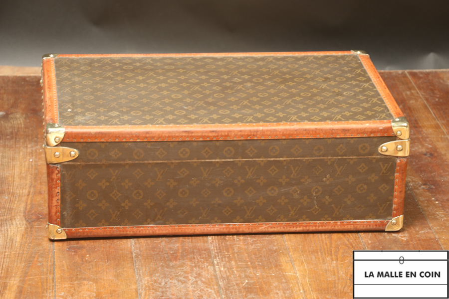 This suitcase from the luxury brand Louis Vuitton is in monogrammed canvas