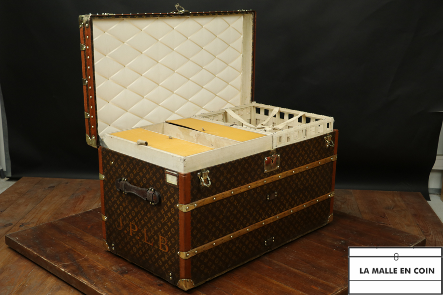 Lot - LOUIS VUITTON STEAMER TRUNK Exterior with all over LV monogram with  beechwood slats, brass lock and handles and hardware.Interior fi
